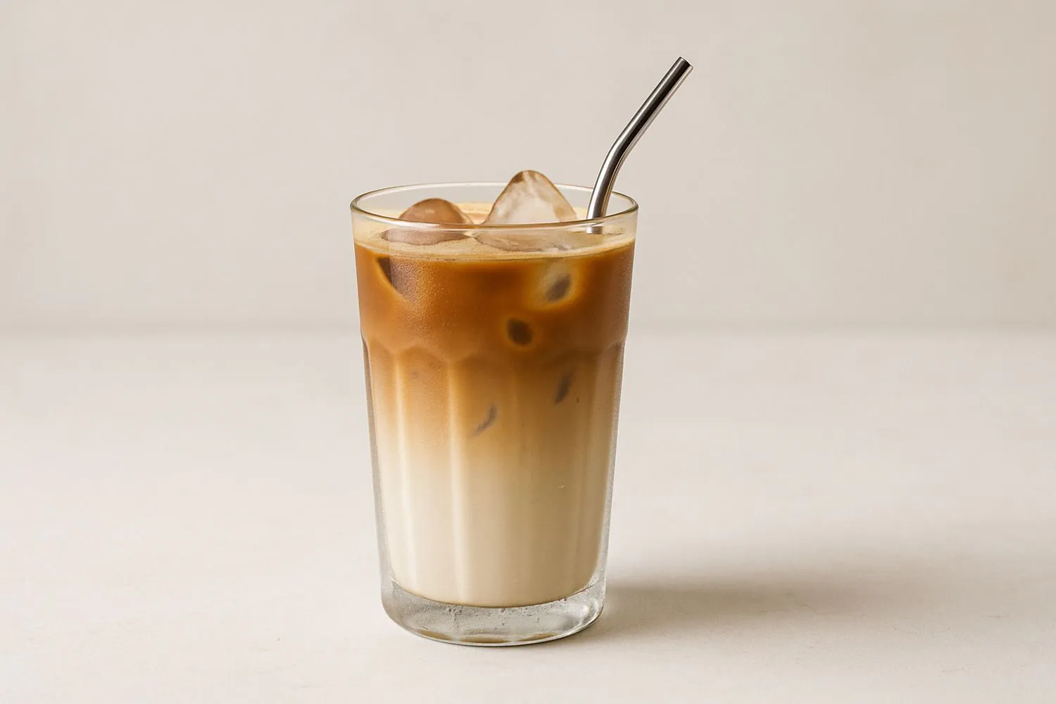 Iced coffee latte with layered milk and espresso at Tangscape, a Cafe in Forest Hills