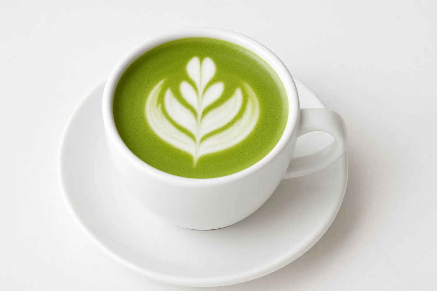 Artfully latte art matcha latte in a white ceramic cup at Tangscape, a Cafe in Forest Hills