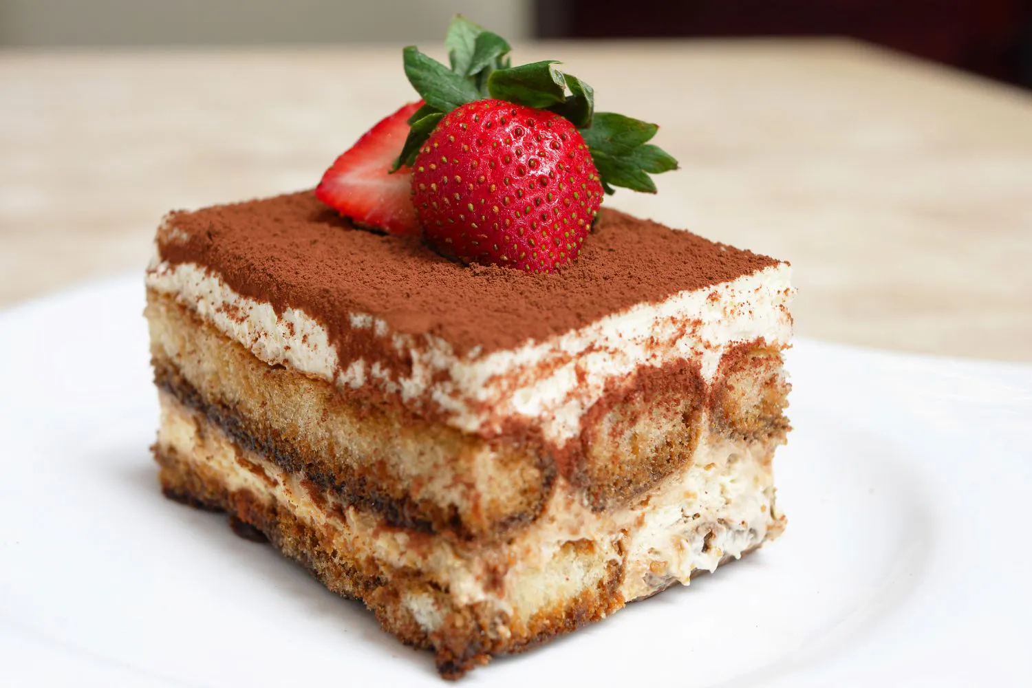 Classic tiramisu dessert topped with fresh strawberries at Tangscape, a Cafe in Forest Hills